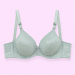 Mint green bra with floral embroidery on a light pink background