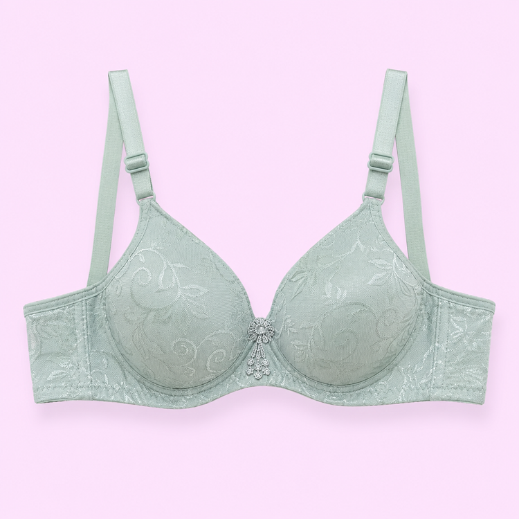 Mint green bra with floral embroidery on a light pink background